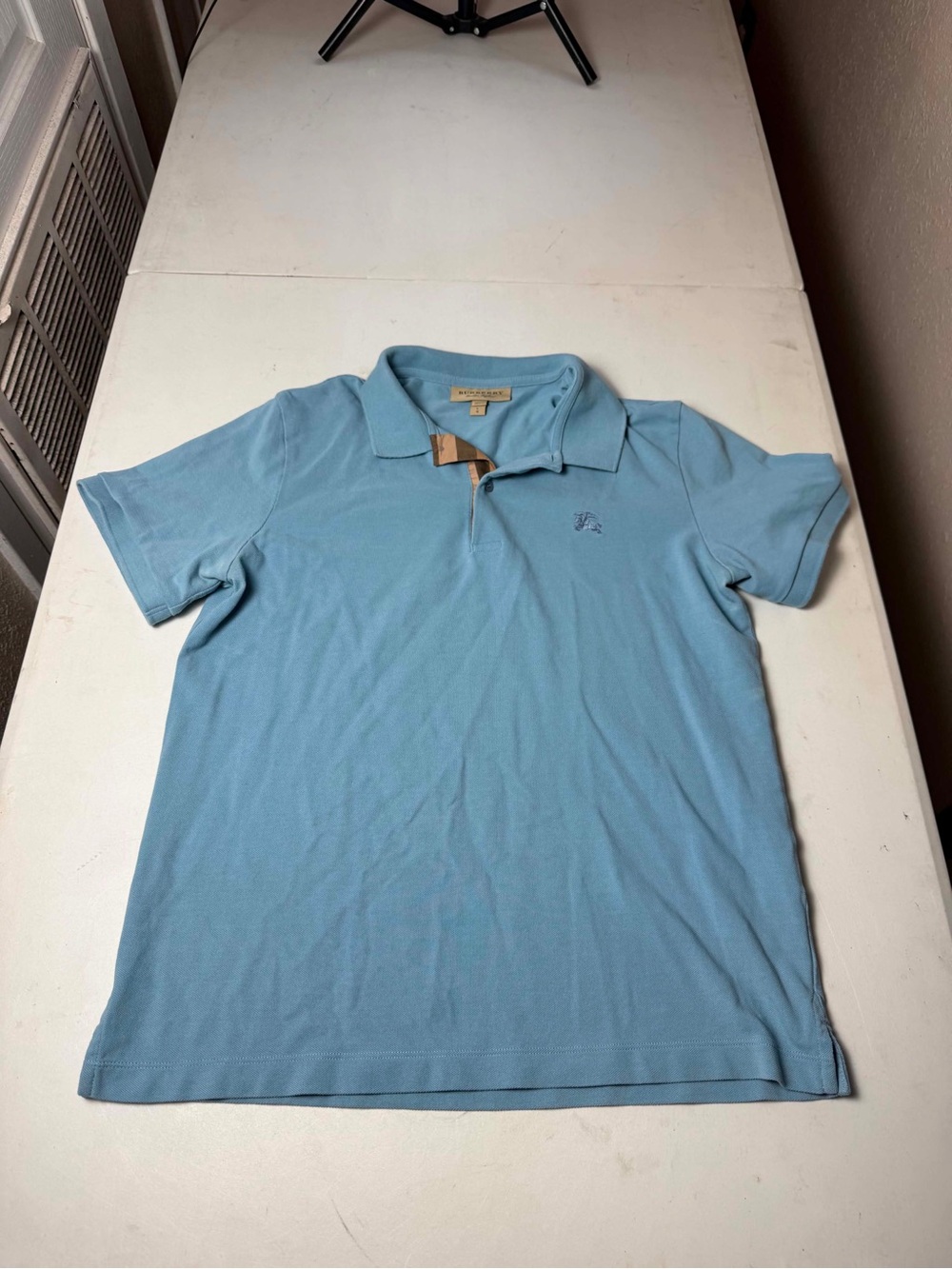 Women Burberry short-sleeve polo shirt in a light blue or cornflower blue Sz L